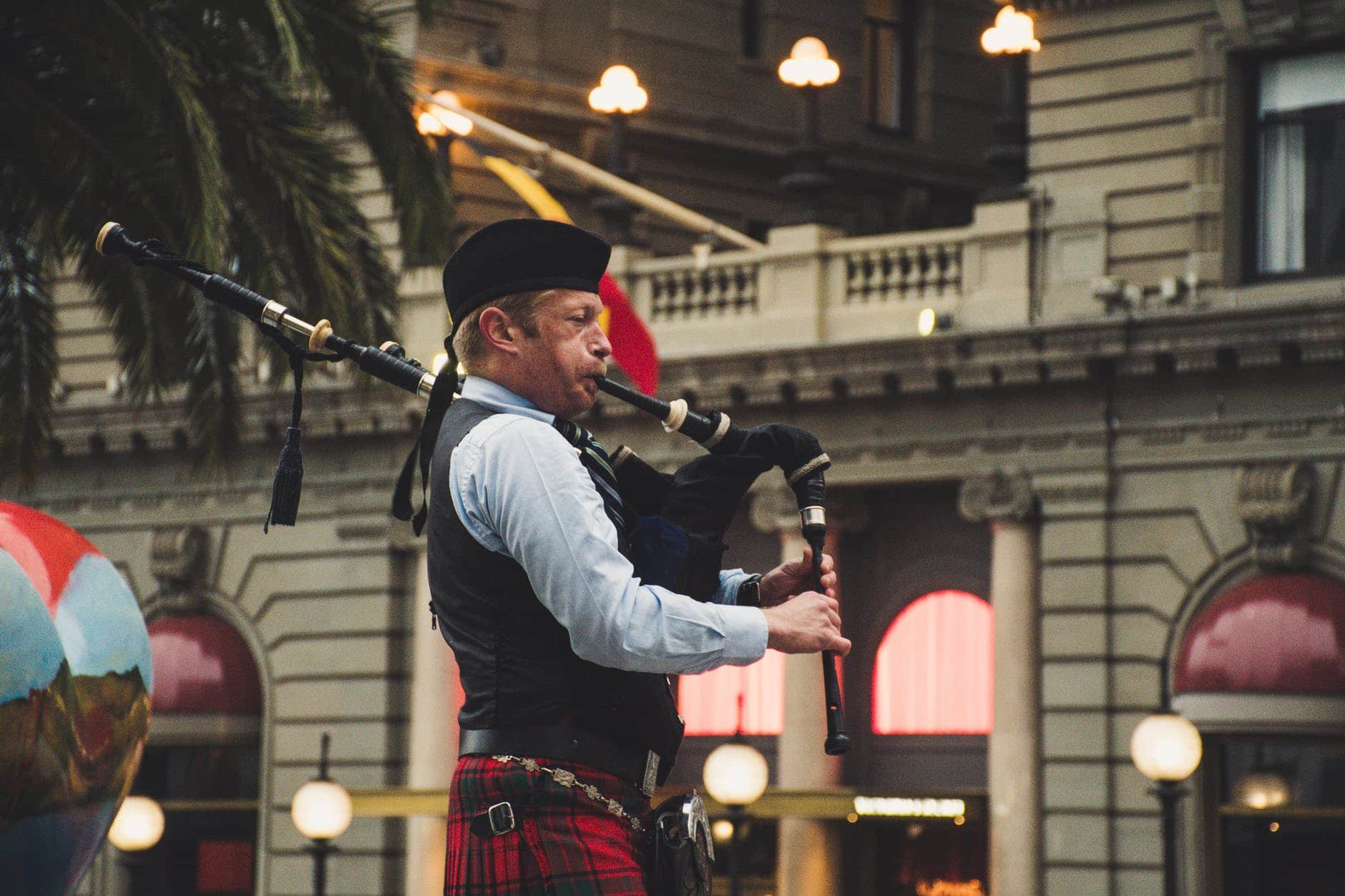 A person playing bagpipes in a building