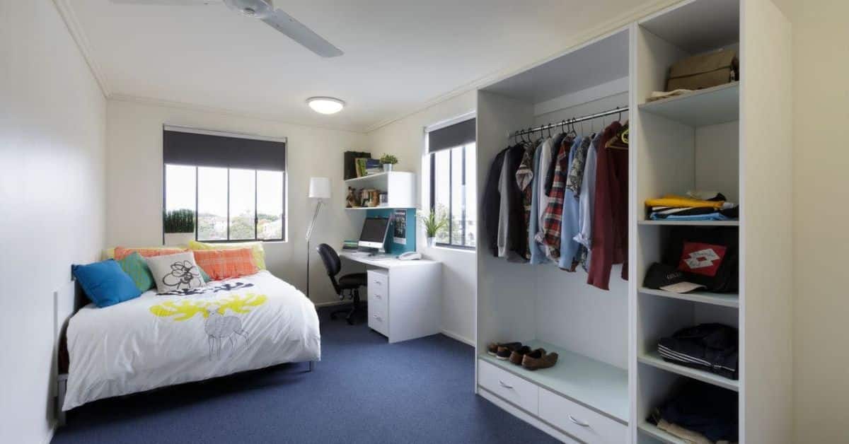 A bedroom with a bed and a desk in Sydney