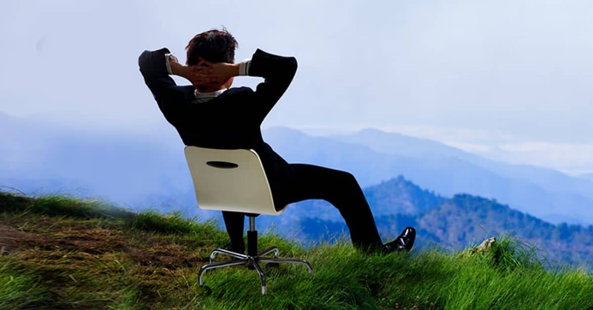 A person sitting in a chair on a hill