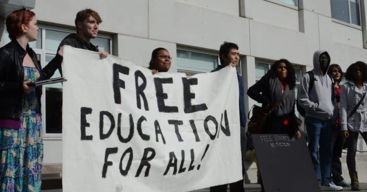A group of people holding free education banner